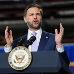 Vice President JD Vance speaking at a lectern while gesturing with his hands. 