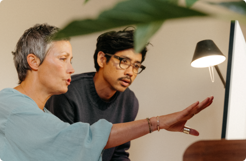 Photo-of-a-woman-and-man-looking-at-a-computer-monitor
