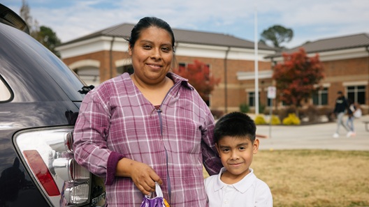 Woman standing next to child