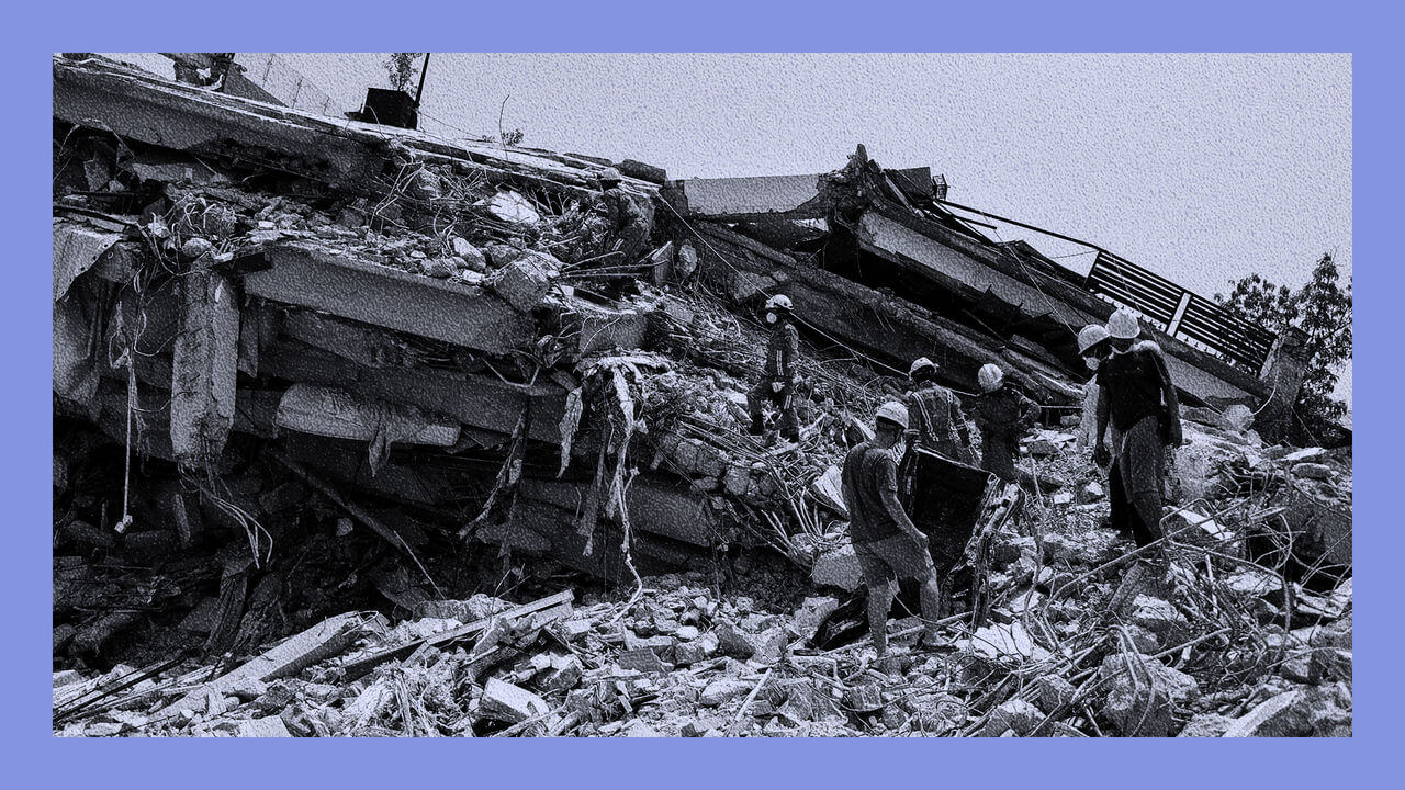 Rescue workers search through the site of a collapsed building in the aftermath of an earthquake