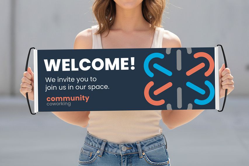 Person holding a custom welcome banner with coworking space branding and modern graphic design