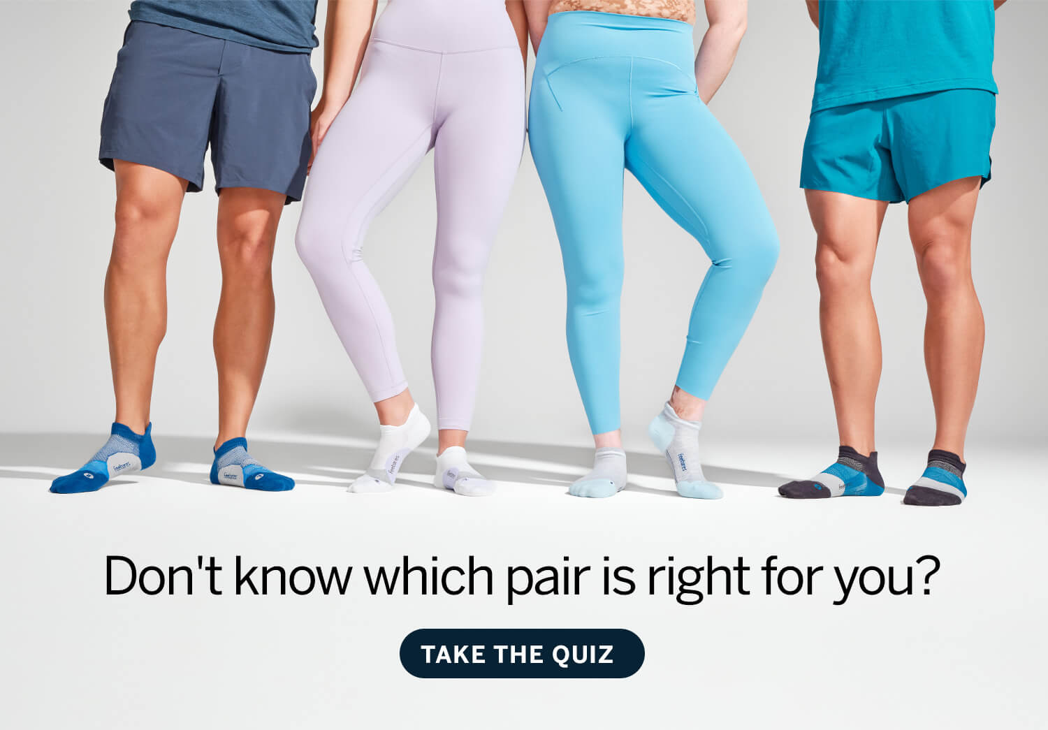Four people standing around wearing Feetures Elite Tabs. two girls and two guys. Don't know which pair is right for you? Take the quiz. 