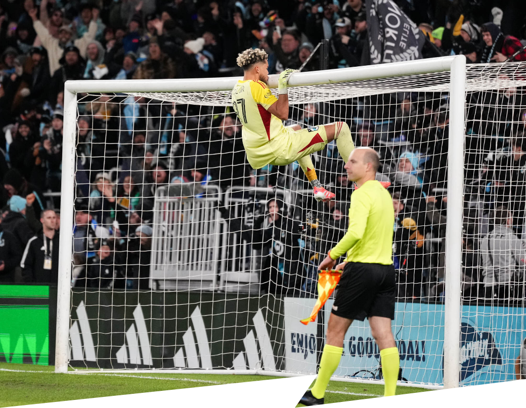 Dayne St. Clair hangs on the goalpost during the PK shootout against Seattle