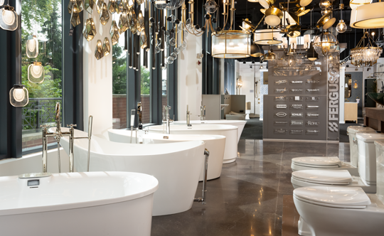 A spacious bathroom featuring multiple sinks and toilets arranged for efficient use and convenience.