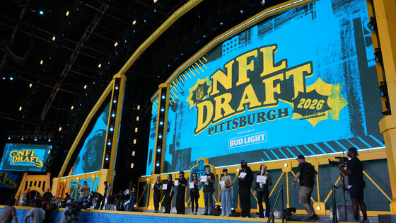 People on a stage under a sign reading 