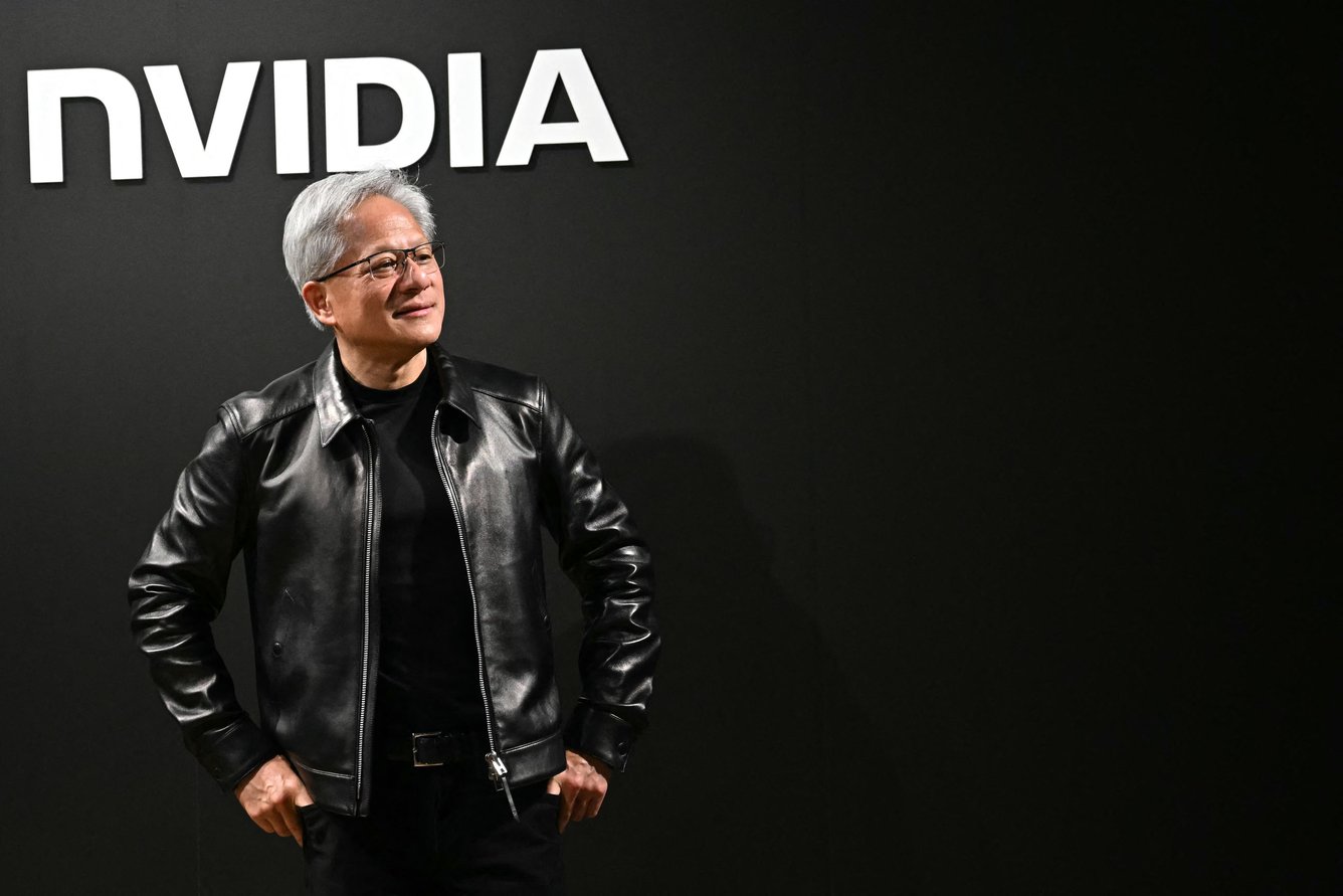 Jensen Huang in front of an Nvidia backdrop