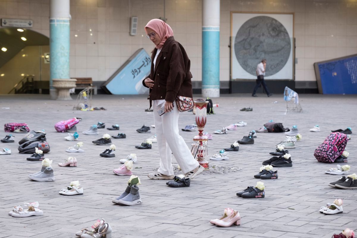 A woman walks through memorial in Tehran for the children killed in a US airstrike in Minab, Iran, on April 22, 2026.