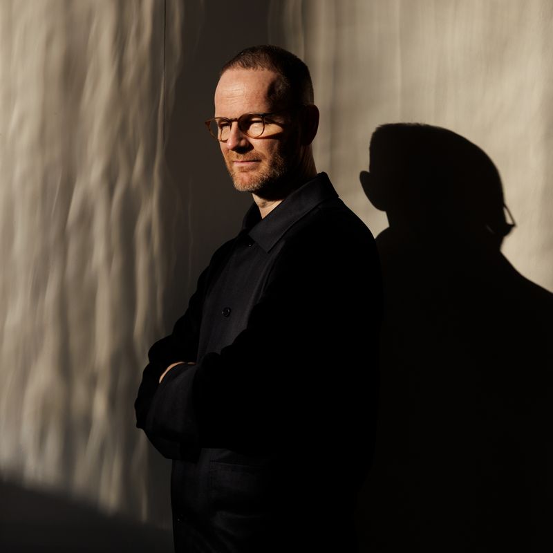 A man partially obscured by shadows