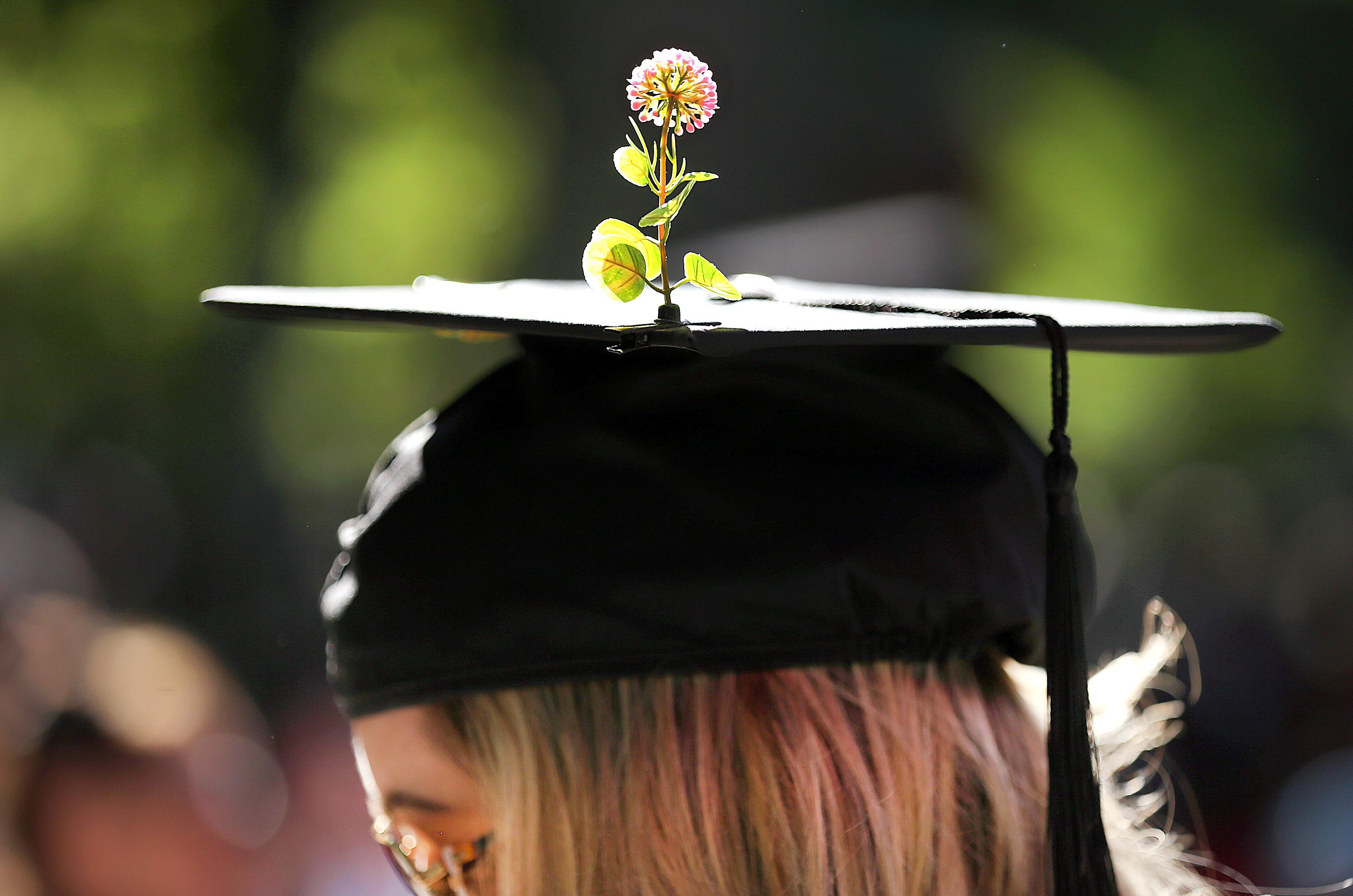College grad with flower on hat