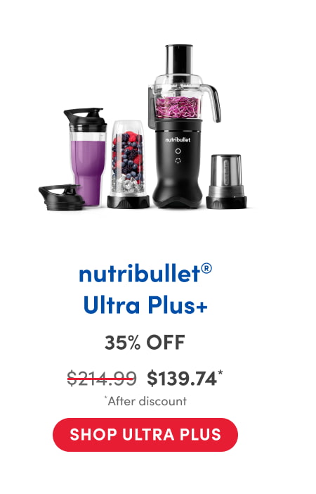 A nutribullet appliance set lined up on a white background, featuring a black base motor with attachments for blending and food processing. The set includes a tall blending cup filled with purple smoothie, a blending cup with mixed berries and ice, a food processor bowl with shredded cabbage, a grinding blade cup, and matching travel lids.