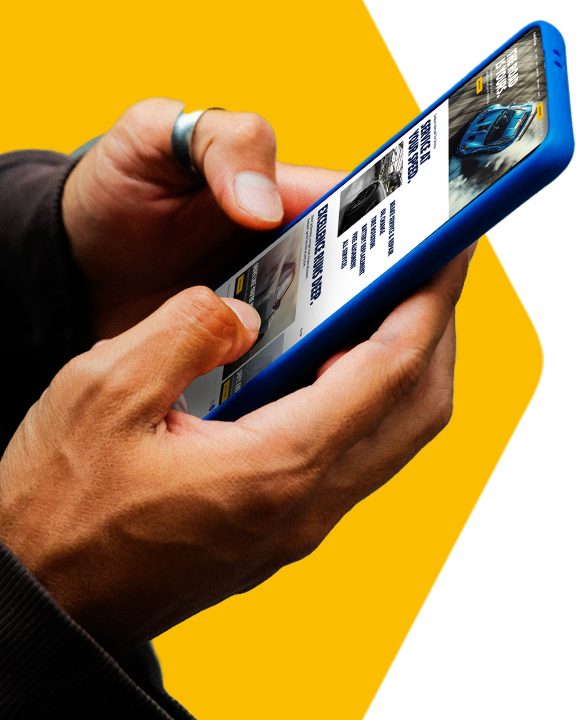 Person holding a mobile phone looking at the new Goodyear website