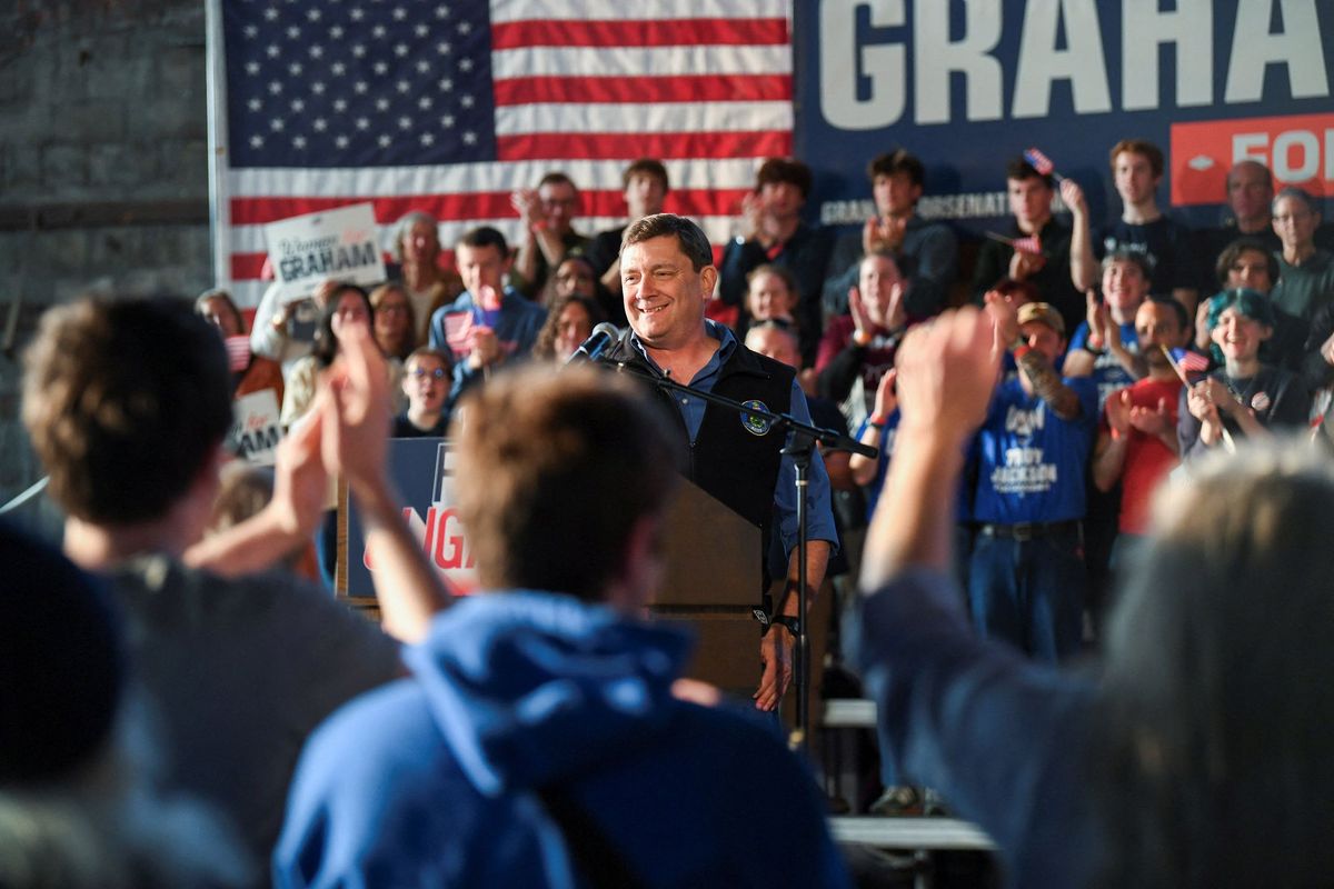 A man speaking to a crowd of political supporters.