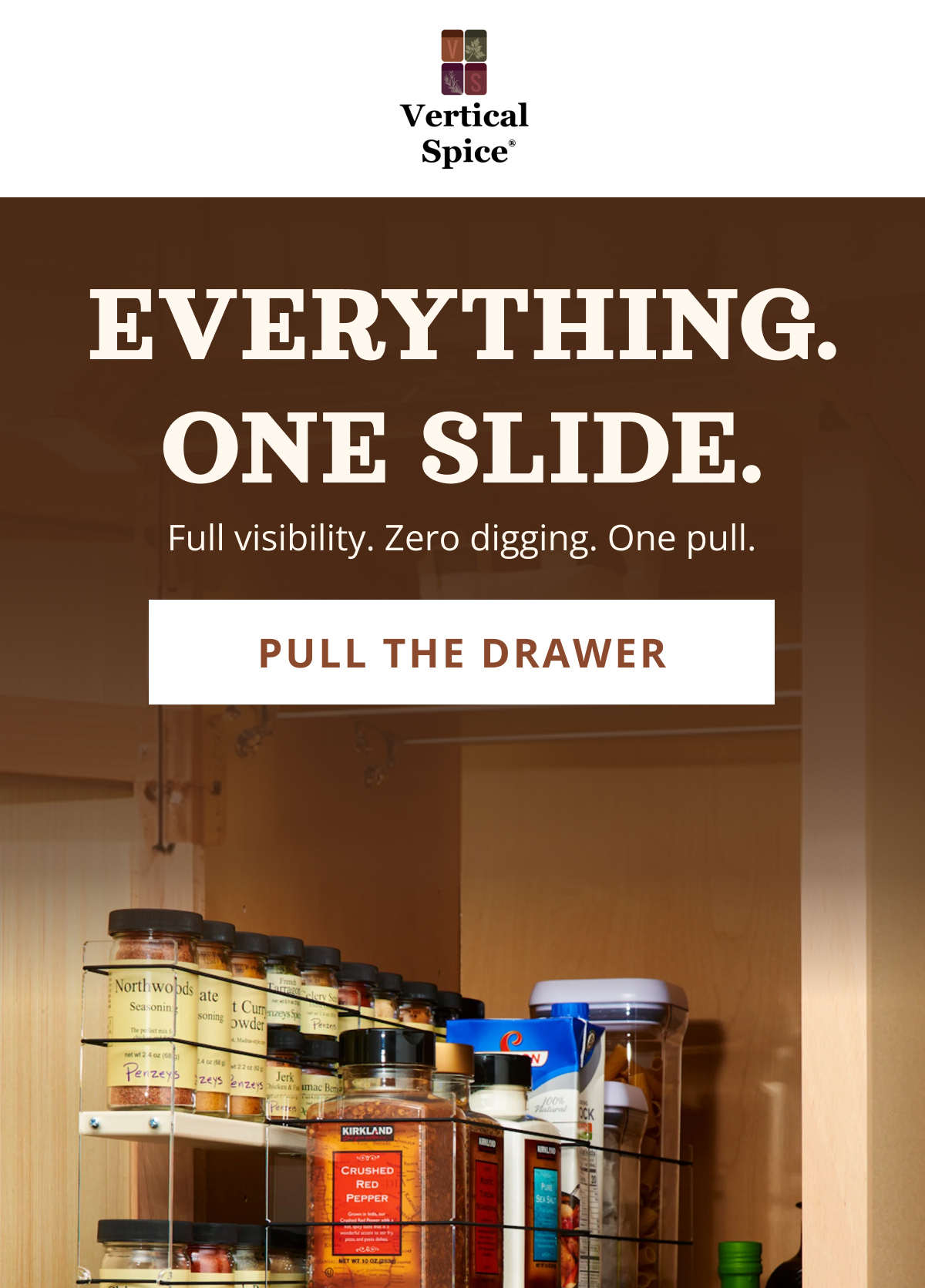 Pull-out spice rack drawer from Vertical Spice installed in kitchen cabinet showing organized spice jars with full visibility