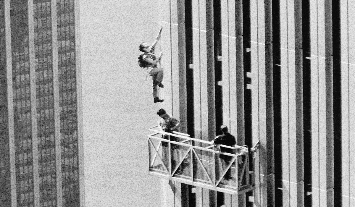 A man climbs up a building.