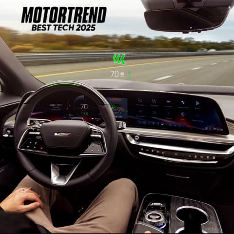 Interior of the 2026 LYRIQ-V showing a man with his hands off the steering wheel and SuperCruise engaged.