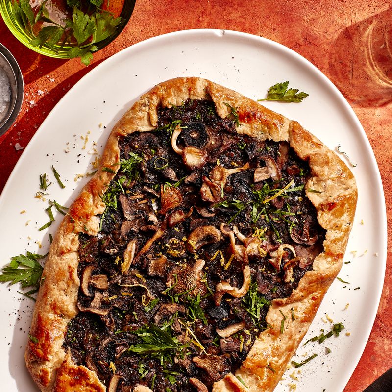 A rectangular Cheesy Mushroom Galette on a white serving platter
