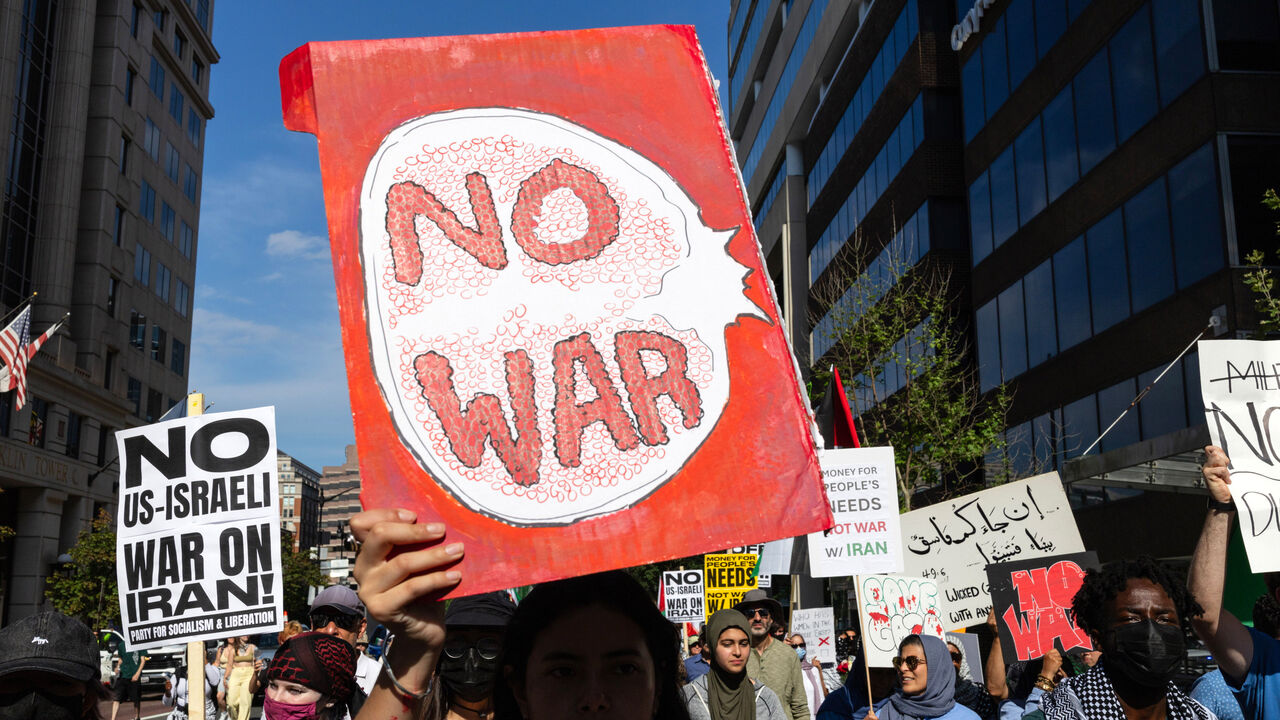 A demonstrator holding a No War sign protests in the United States.