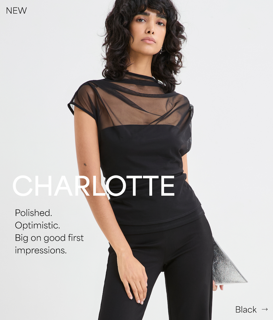 Emma wears The Dawn Top with a sheer draped neckline, described as “Polished. Optimistic. Big on good first impressions.”.