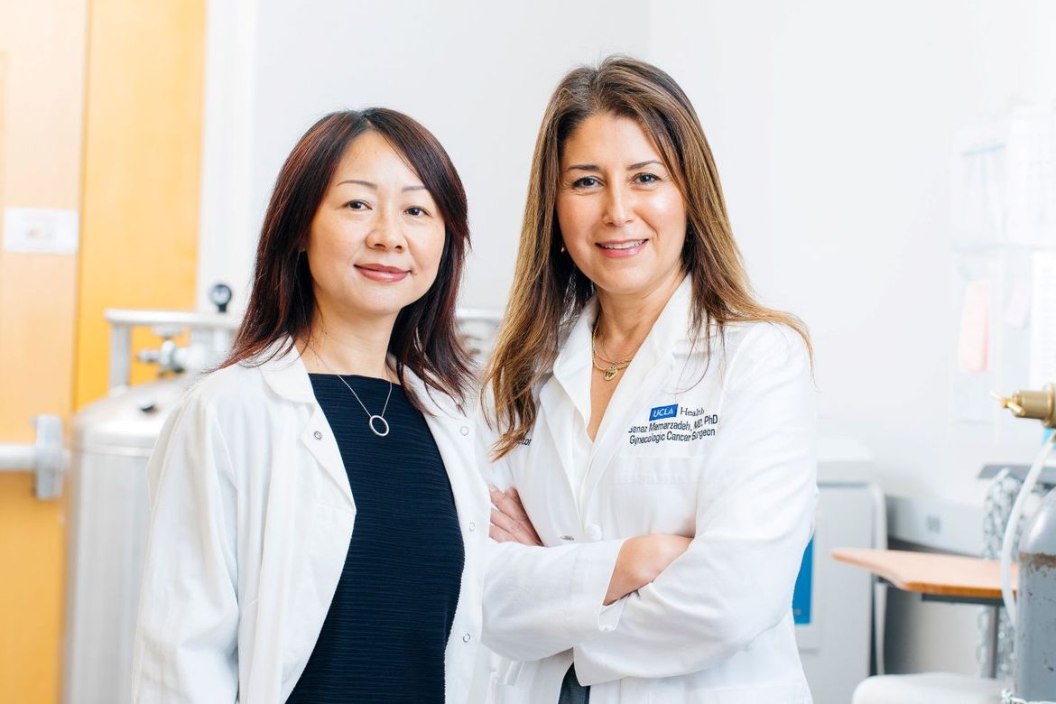 Lili Yang and Sanaz Memarzadeh in white UCLA lab coats
