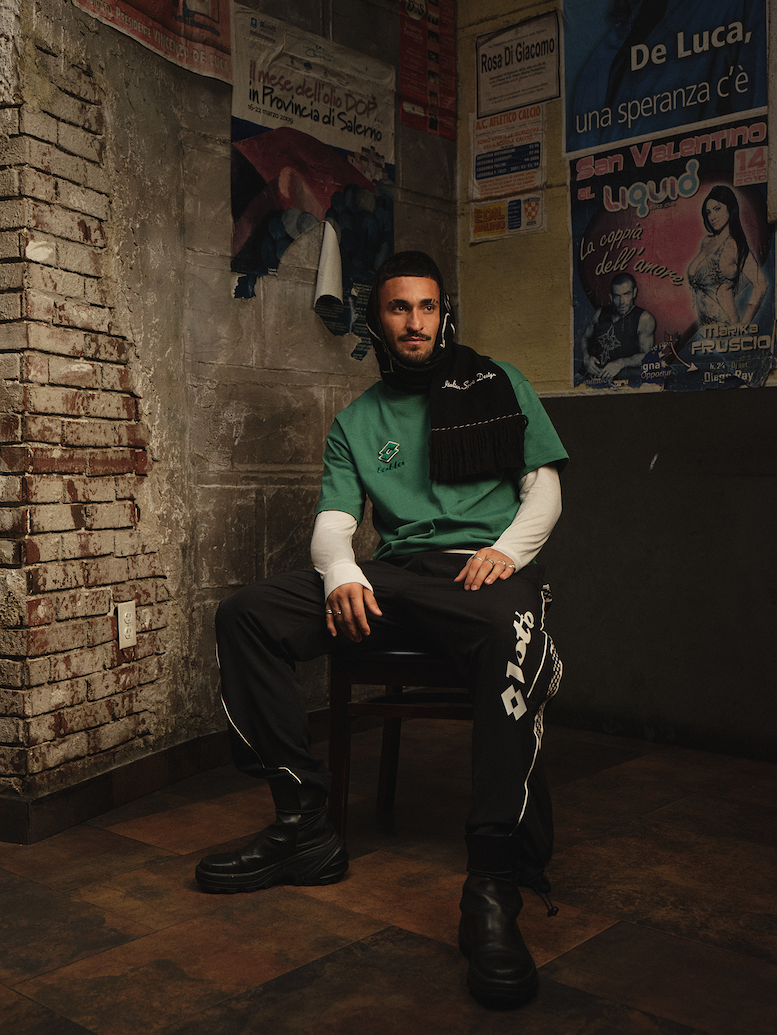 Man wearing green Lotto shirt and black Lotto pants