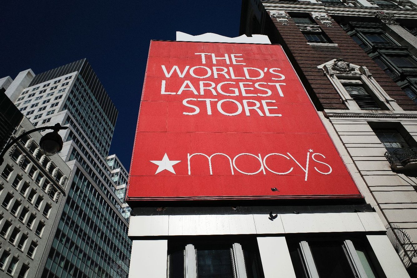 Photo of the Macy's storefront in Herald Square in New York, with a huge sign on the facade that says "The World's Largest Store" in white lettering on Macy's iconic red background.