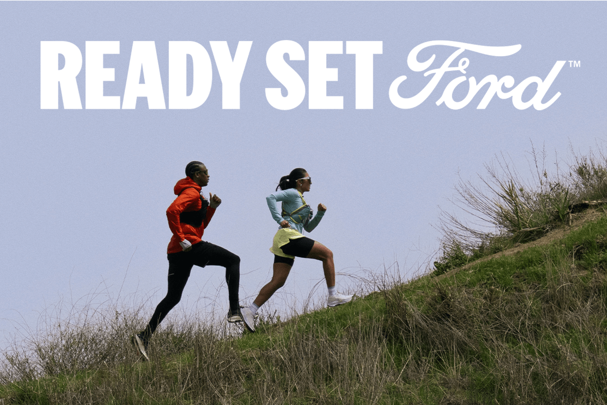 Two people running up a grassy hill with text reading &ldquo;Ready Set Ford&trade;&rdquo; above