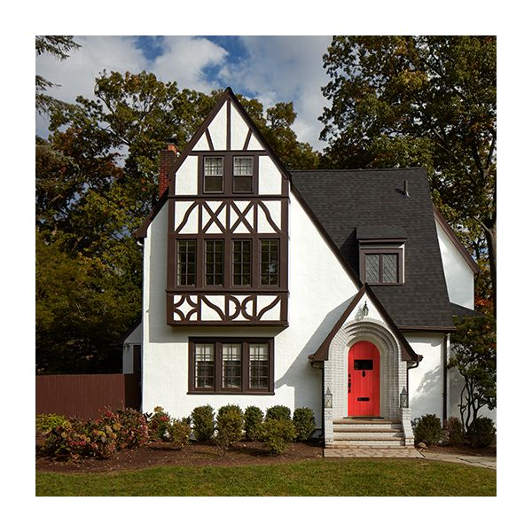 A white painted home exterior with brown trim and a red front door.