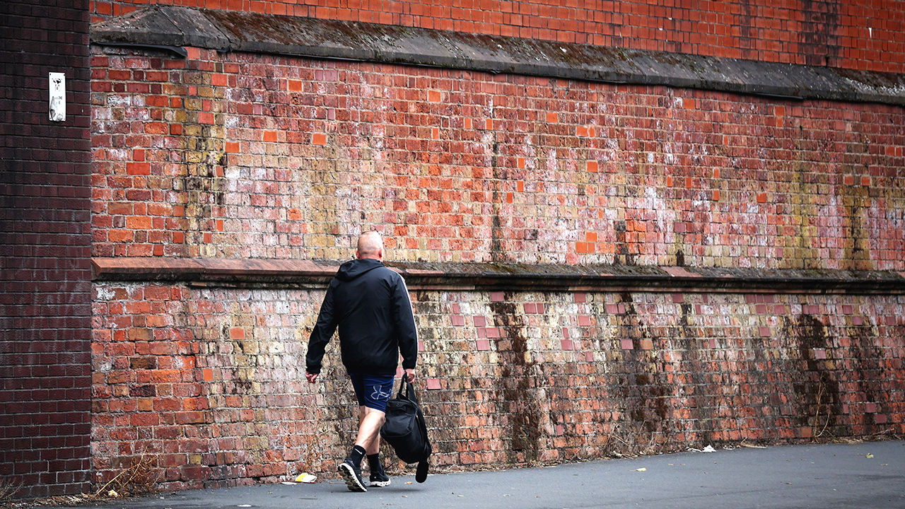 A person carrying a holdall bag walks past HM Prison Liverpool 