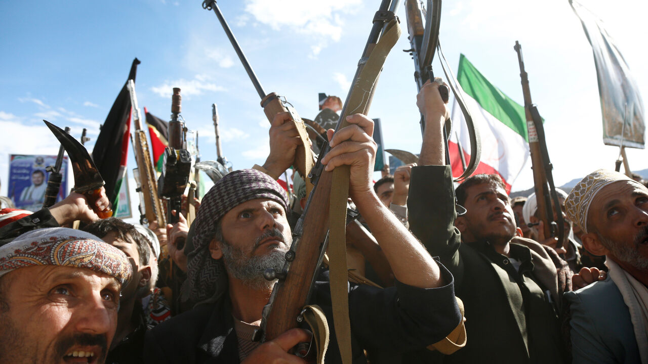 Yemen's Houthi loyalists chant slogans as they participate in a protest staged to show support to Iran against the U.S.-Israel war.