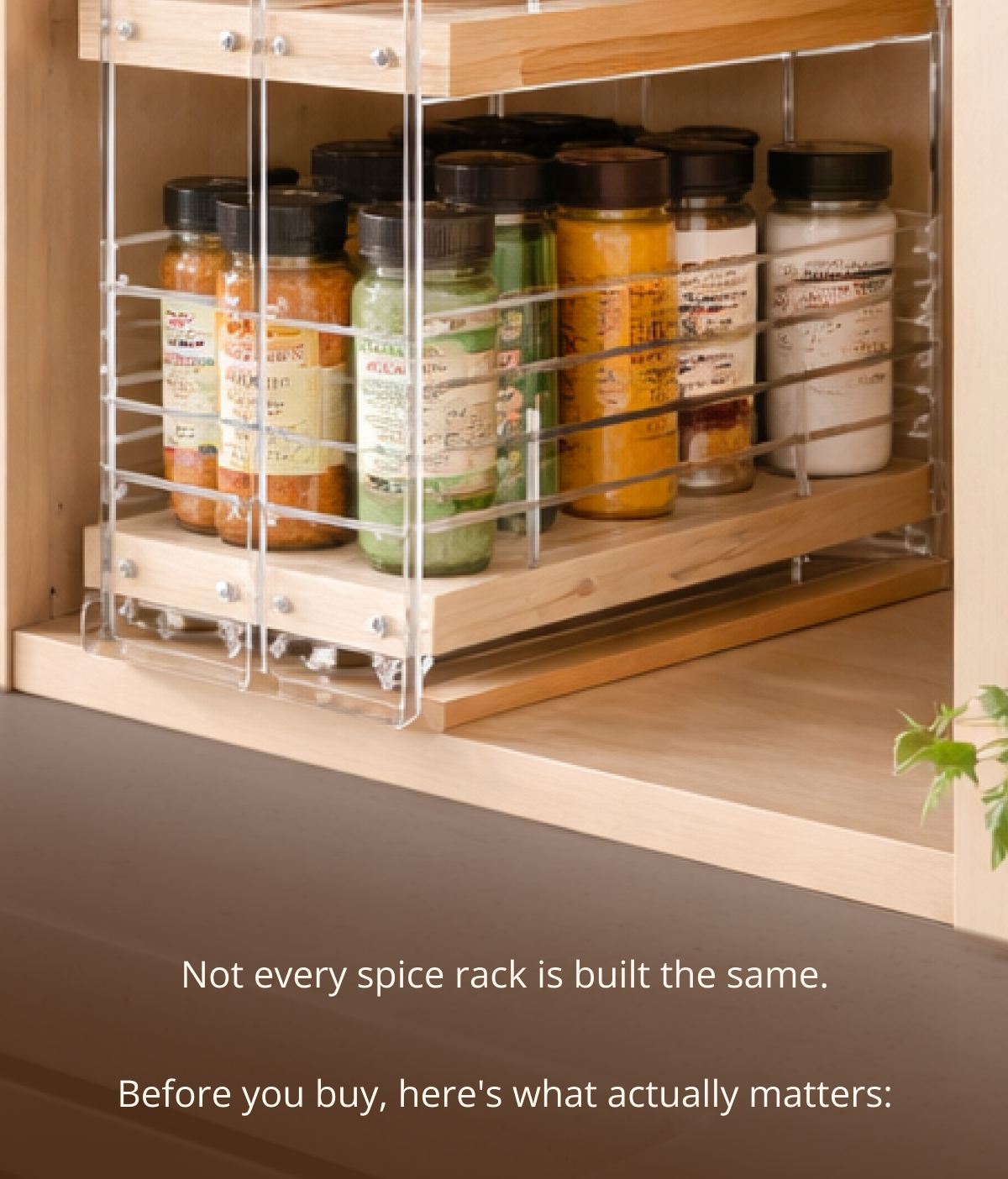 Sliding spice rack organizer fully extended in wooden kitchen cabinet showing neatly arranged spice jars
