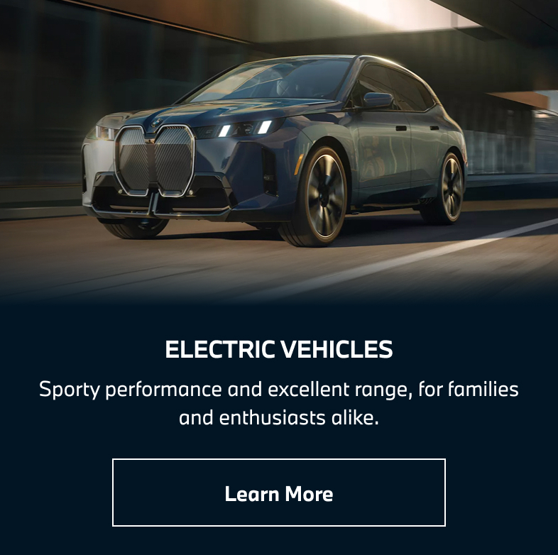 BMW iX driving down the road. Learn more.