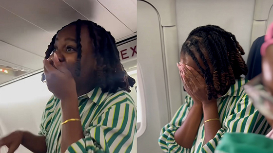 A woman surprised on a plane.