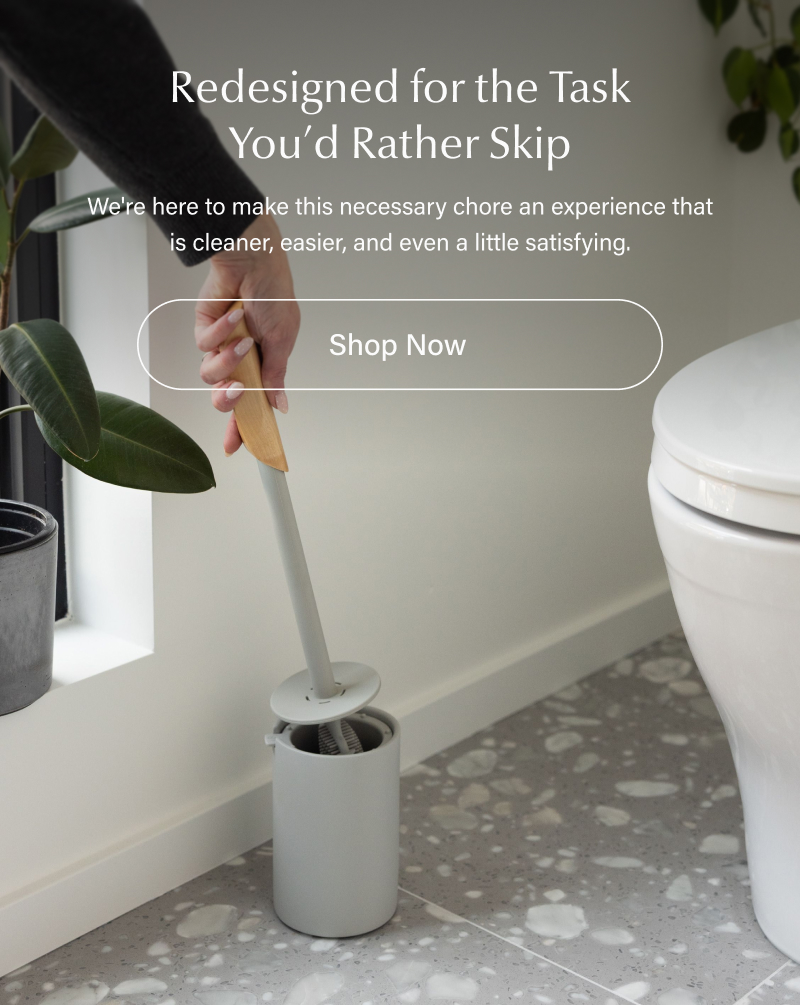 Text reads “Redesigned for the Task You’d Rather Skip. We’re here to make this necessary chore an experience that is cleaner, easier, and even a little satisfying. Shop Now.” Text overlays a lifestyle image of the brush being placed into its holder beside a toilet in a bright, modern bathroom.
