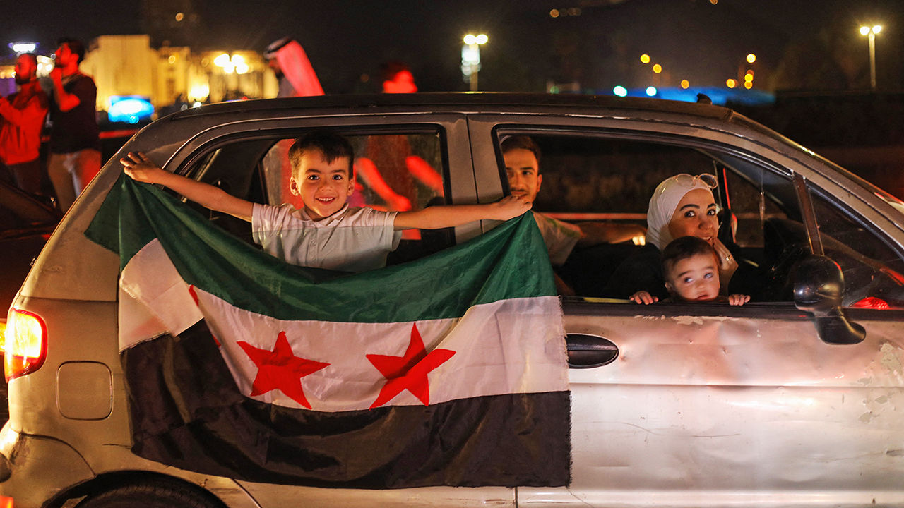 People celebrate in Damascus' Omeyyad square after US President Donald Trump's decision to lift sanctions in Syria