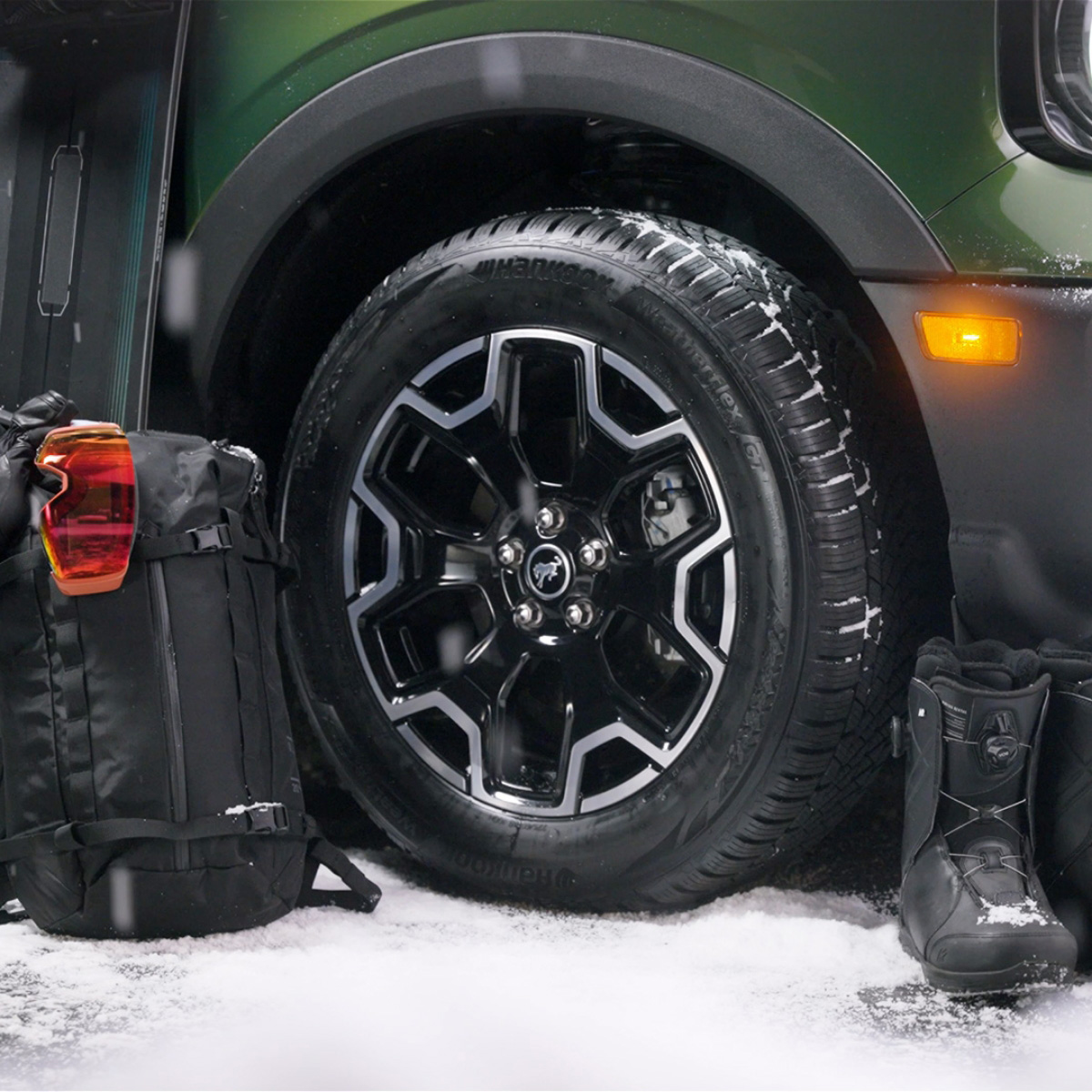Hankook tires on a car next to snowboarding gear.