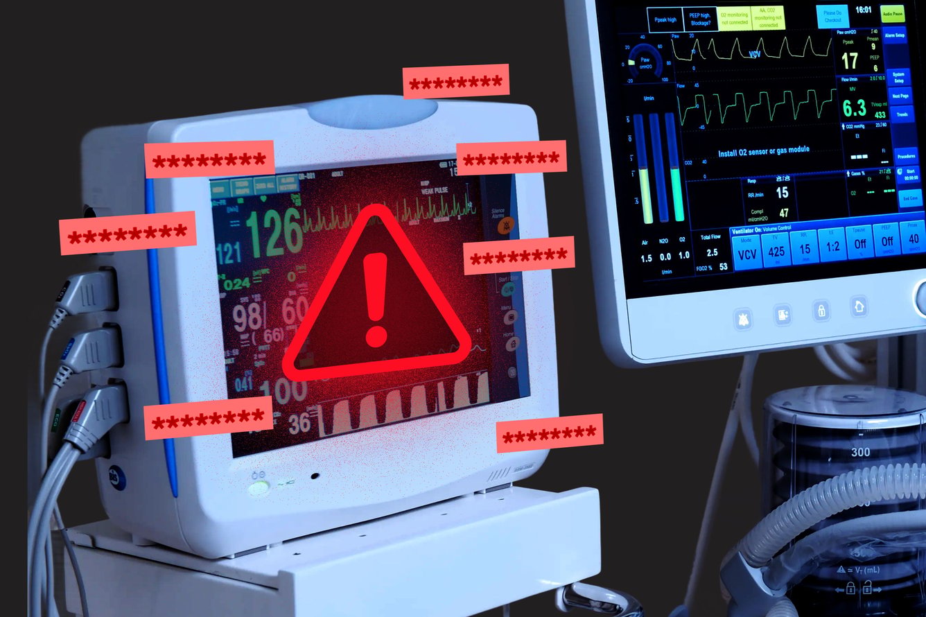 Close-up of the monitors of medical devices with one screen showing a red warning sign.