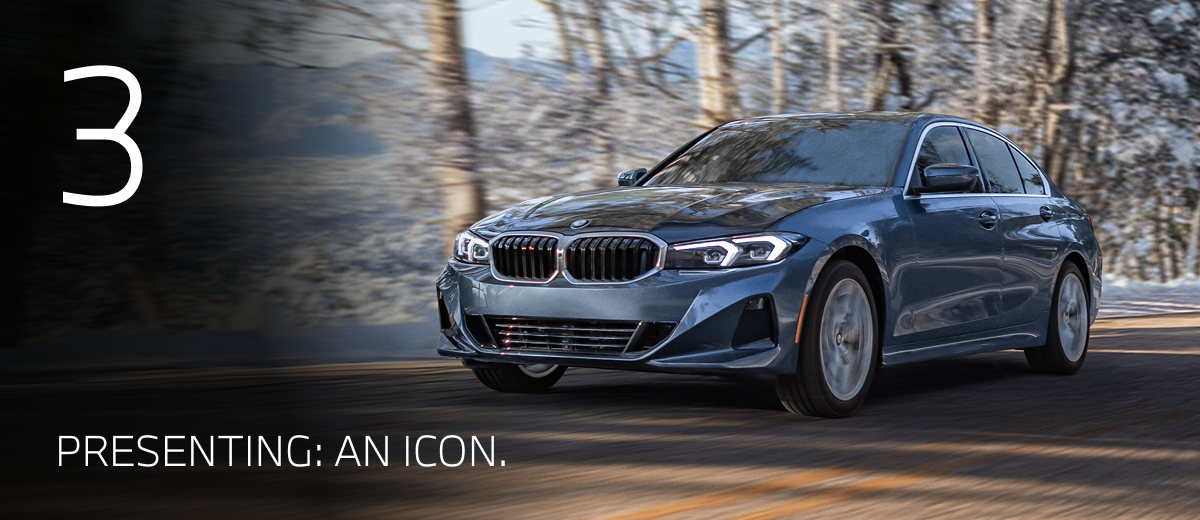 2026 BMW 330i driving down a winter road with snowy trees in the background