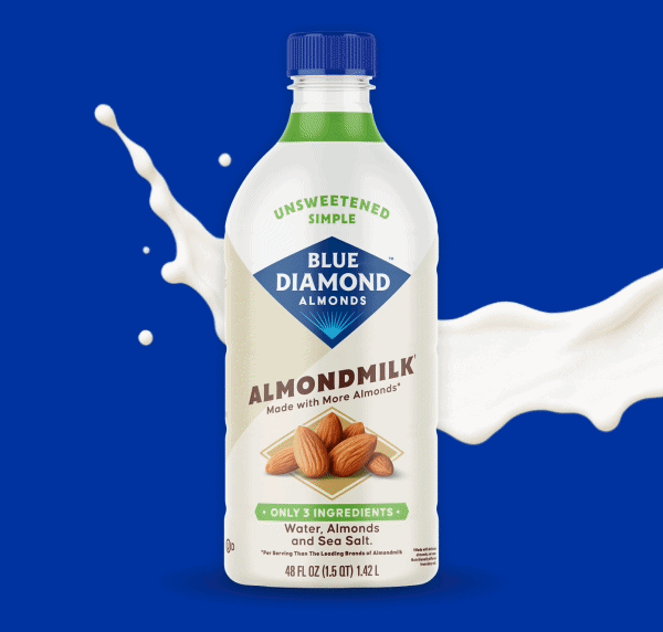 Bottles of Blue Diamond Almondmilk in assorted flavors shown with almonds and a splash of almondmilk on a blue background.