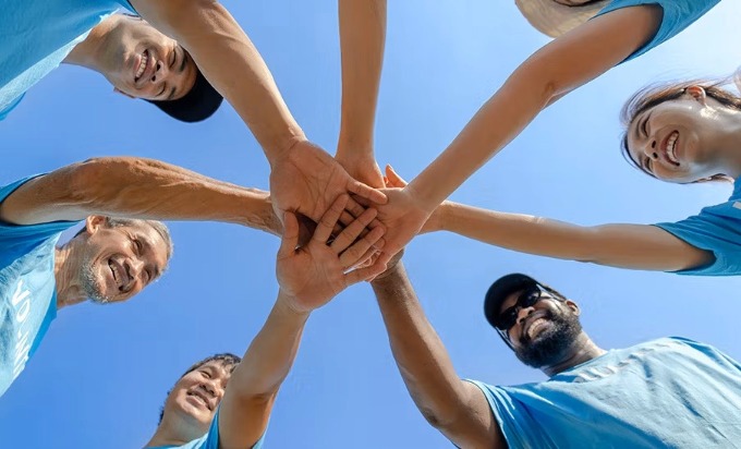  Volunteers put their hands together.