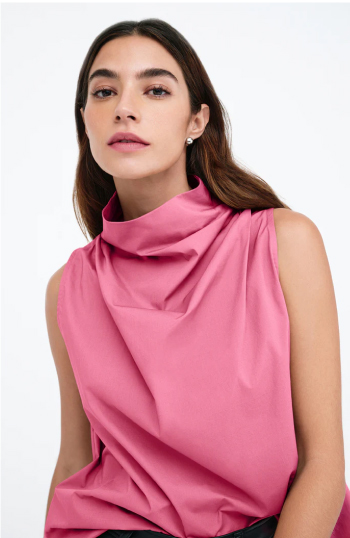 Rocio wears the Minna Top with a draped neckline, facing the camera against a light background.