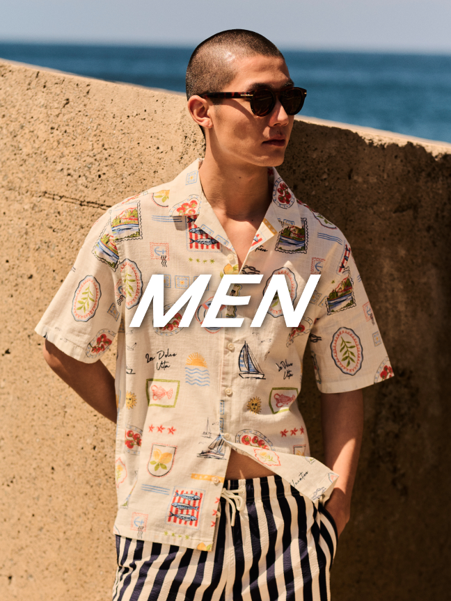 Men. Man wearing a patterned shirt and stripe shorts