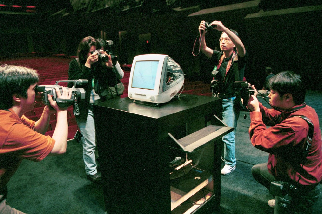 Photographers taking pictures of an Apple computer