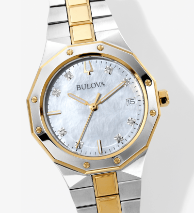 Bulova two-tone watch with a silver dial, diamond accents, gold-tone bezel screws, and date display.