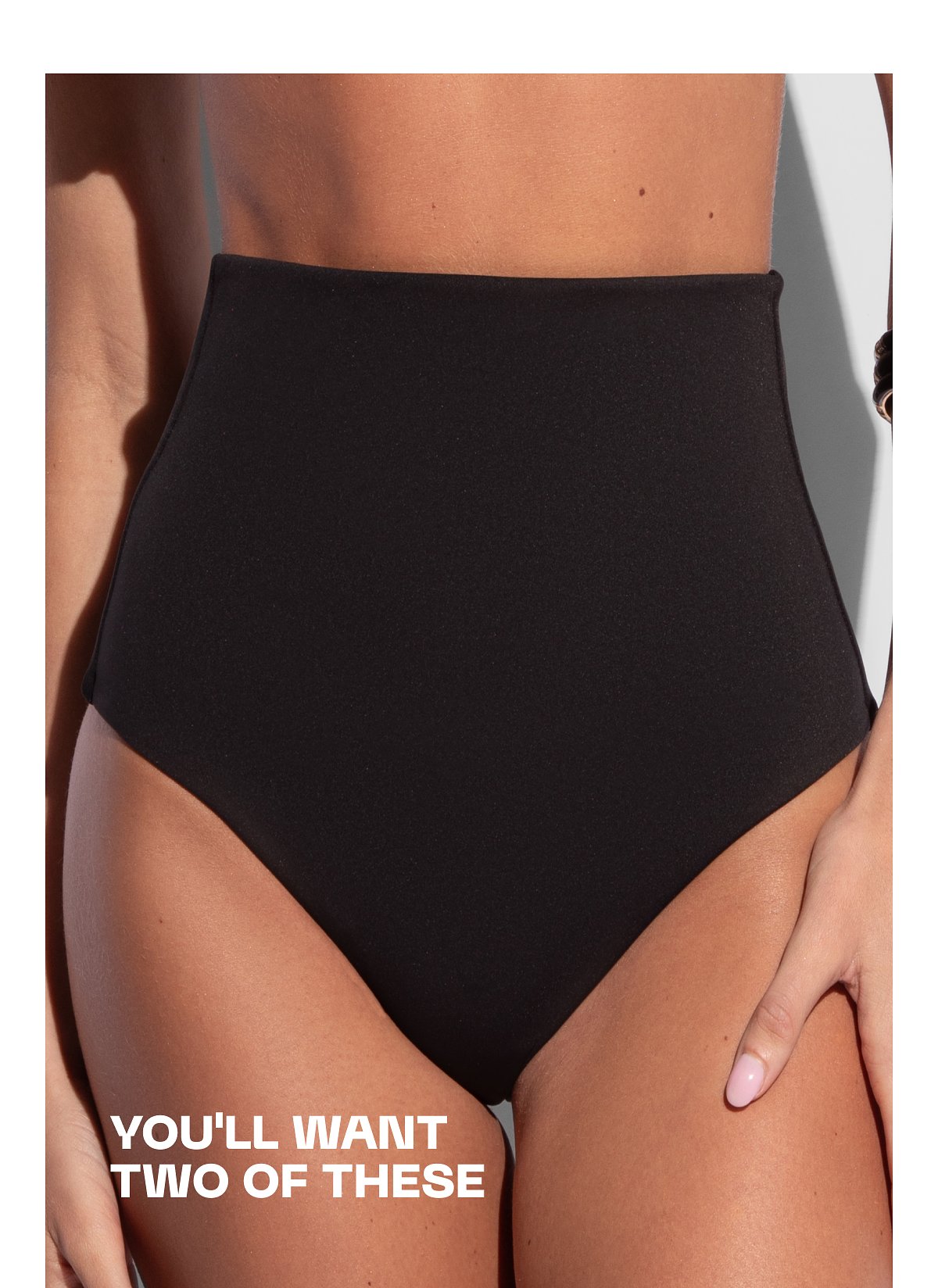 High-waisted black bikini bottom with text: you'll want two of these.