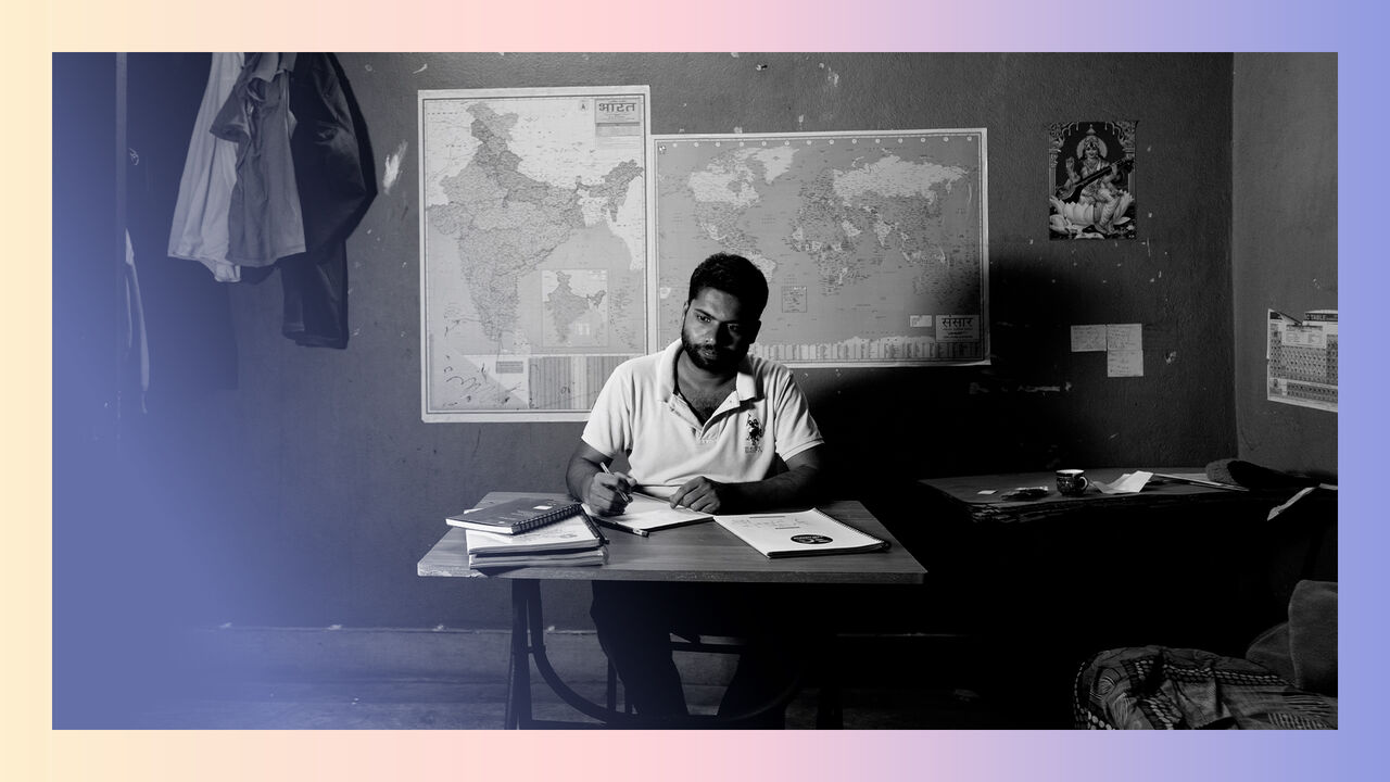 Neeraj Kumar studying in his shared rented accommodation in Bazar Samiti close to Mussalahpur, Patna, Bihar, India. He has been preparing for railway entrance examinations for the past 7-8 years.