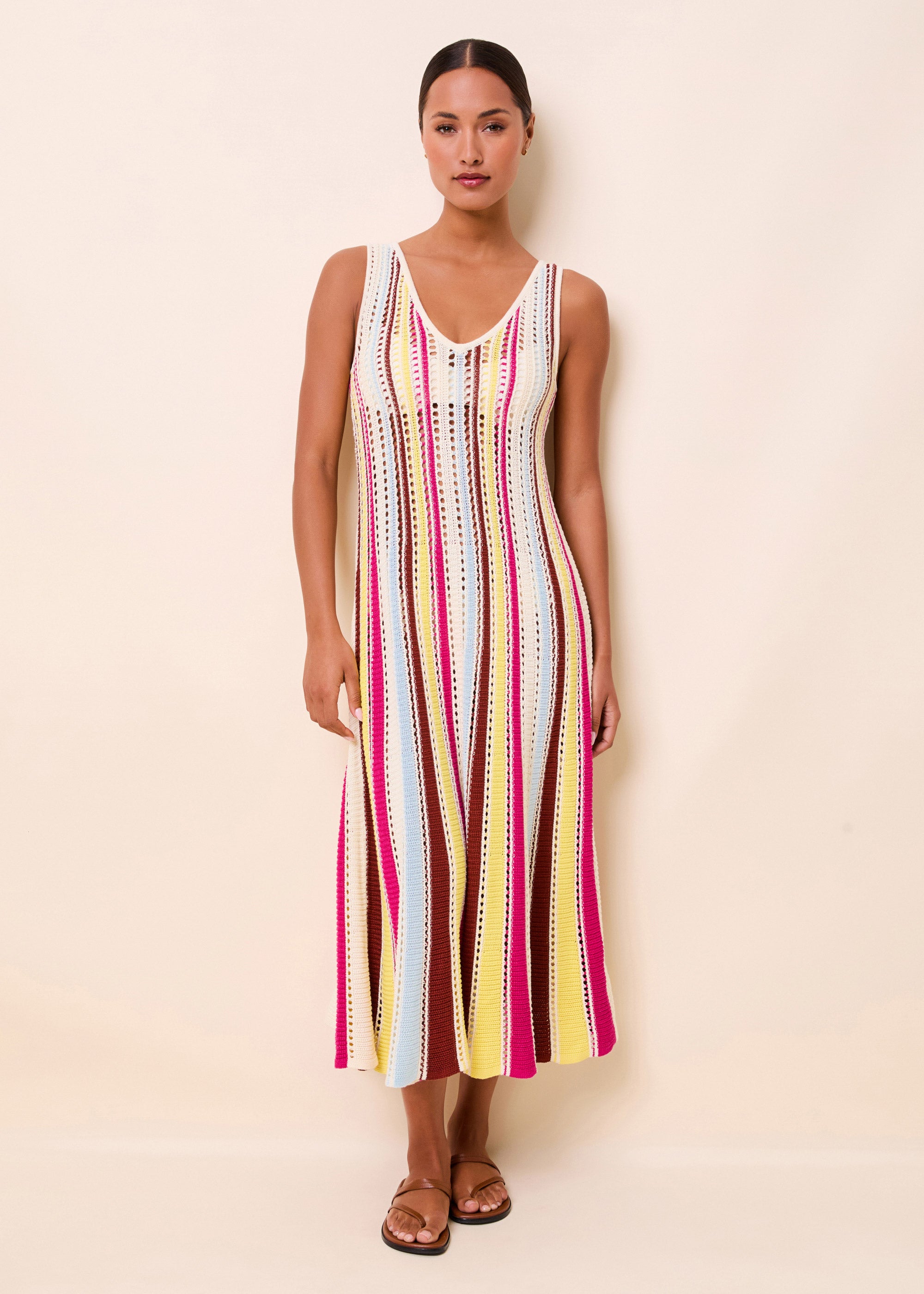 woman in an open knit long dress with colorful stripes