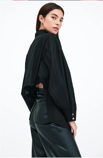 Rocio wearing the Ezra Shirt and black leather pants looks over her shoulder with a confident pose.