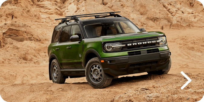 A Bronco&reg; Sport SUV Outer Banks&reg; model being driven off‑road in a desert landscape