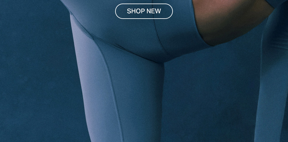 Close-up of blue-grey athletic leggings on a person in motion, emphasizing comfortable fit and sleek fabric. Shop our new collection of activewear now.