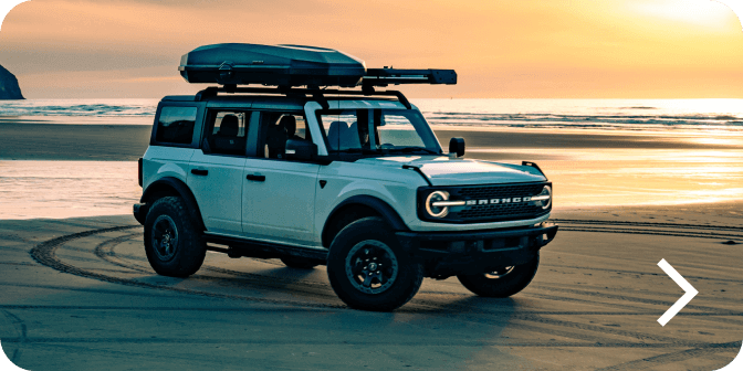 A Bronco&reg; SUV Badlands&reg; model parked on a beach